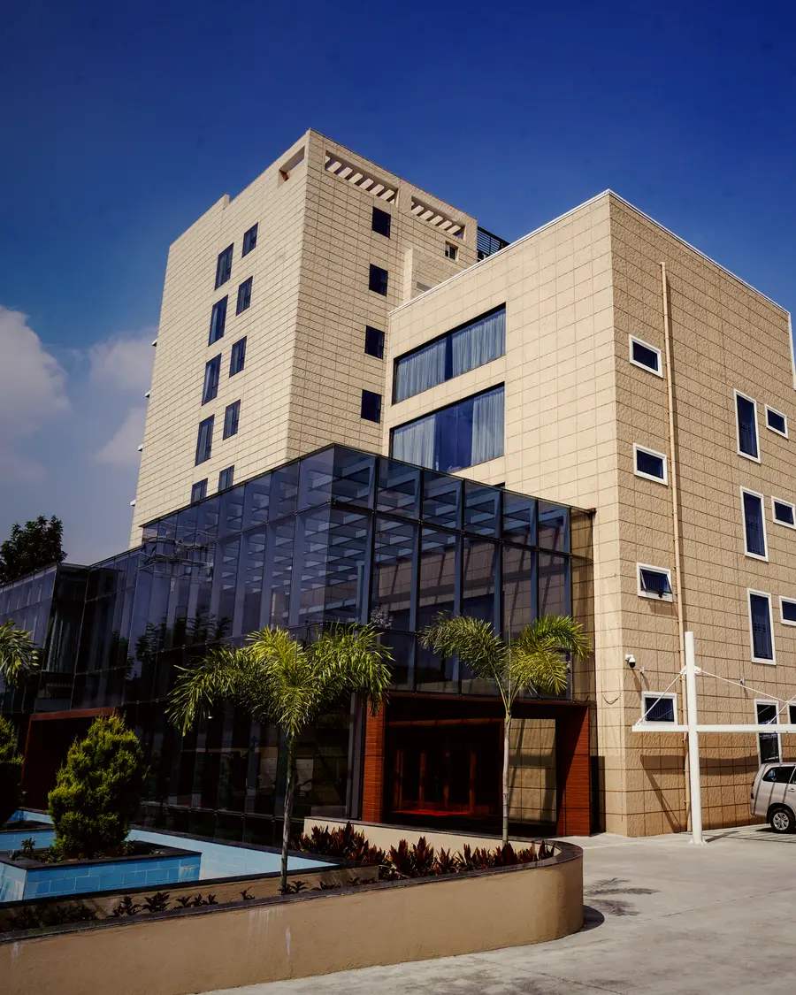 The glazed wing and tower of Hotel Hills Hosur from the forecourt