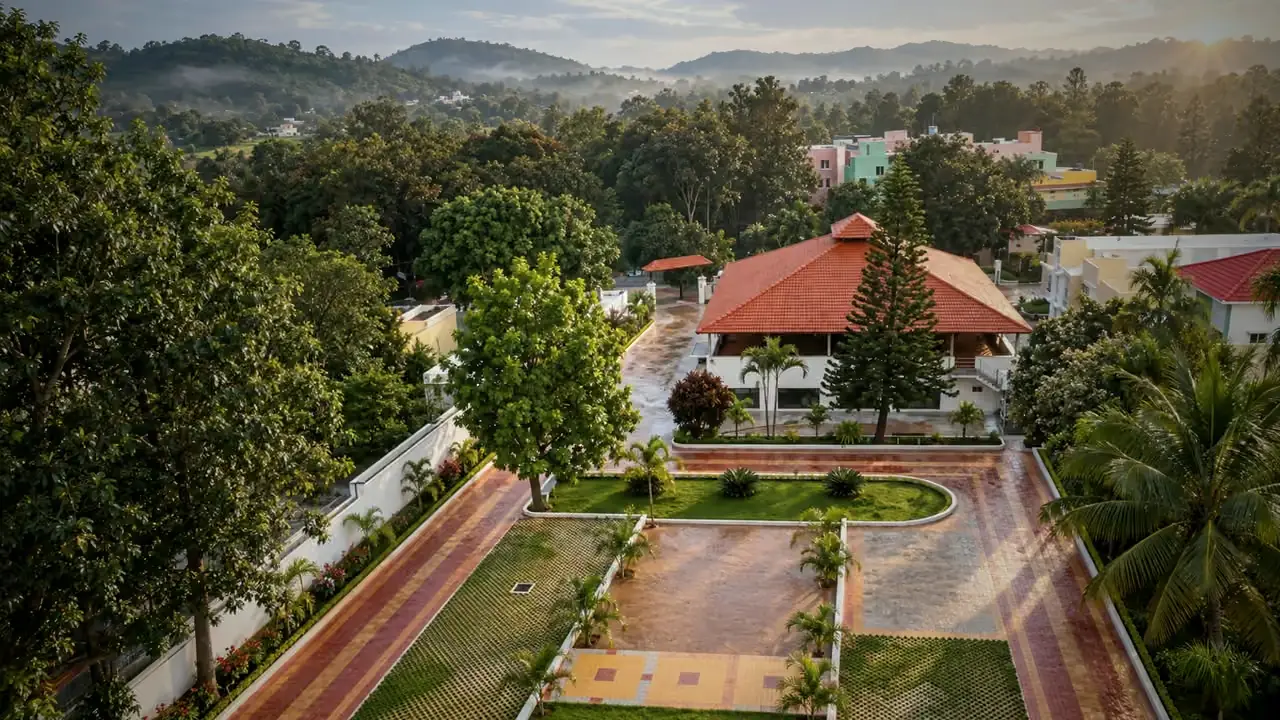 Hotel Hills Yelagiri from above: the red roofed restaurant block, the lawns and the drive, with the hills behind